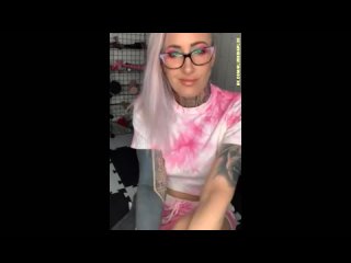 hot blonde stimulates her pussy with a multi-colored dildo.